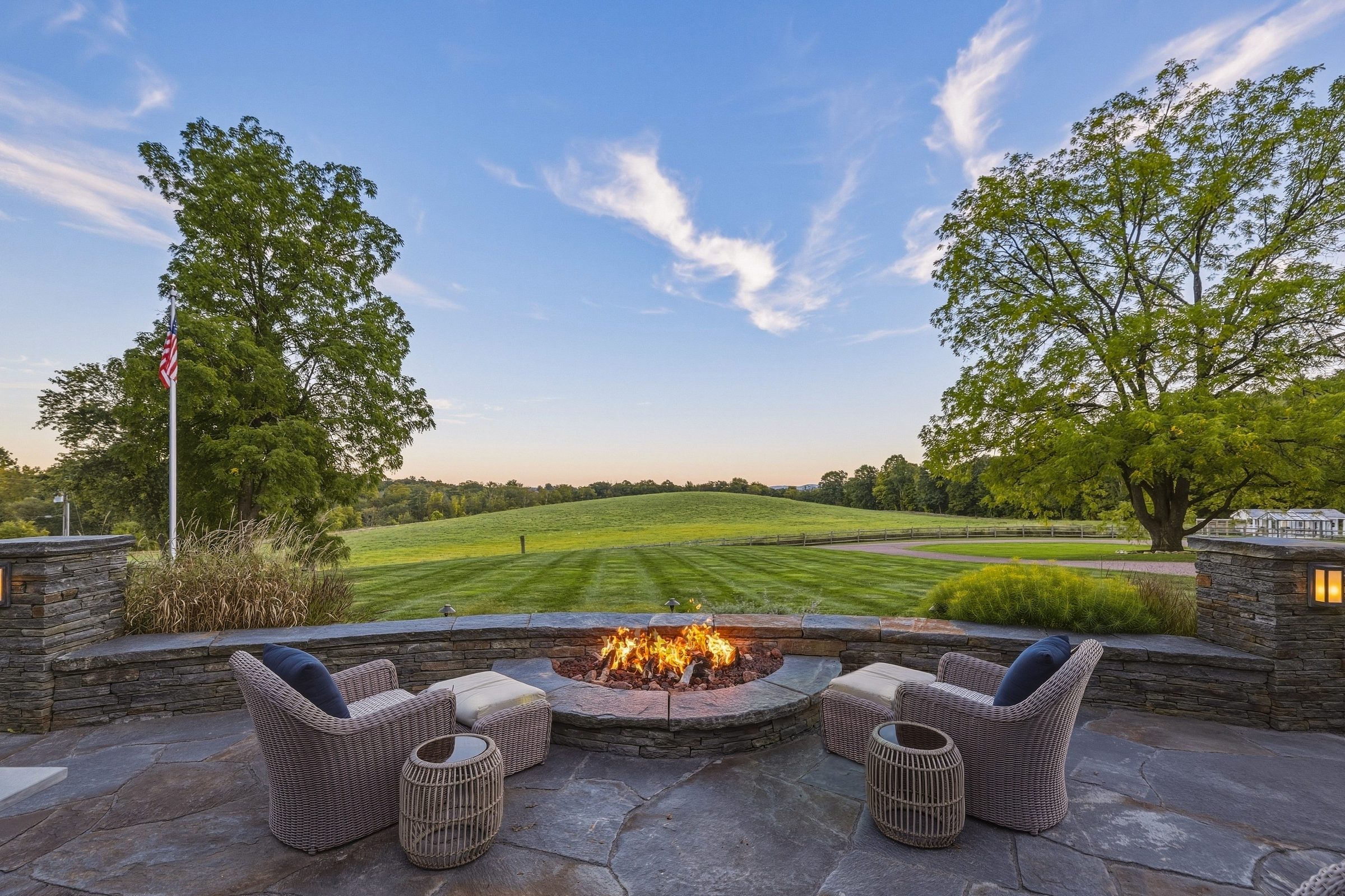 Custom fire pit on a stone terrace at sunset