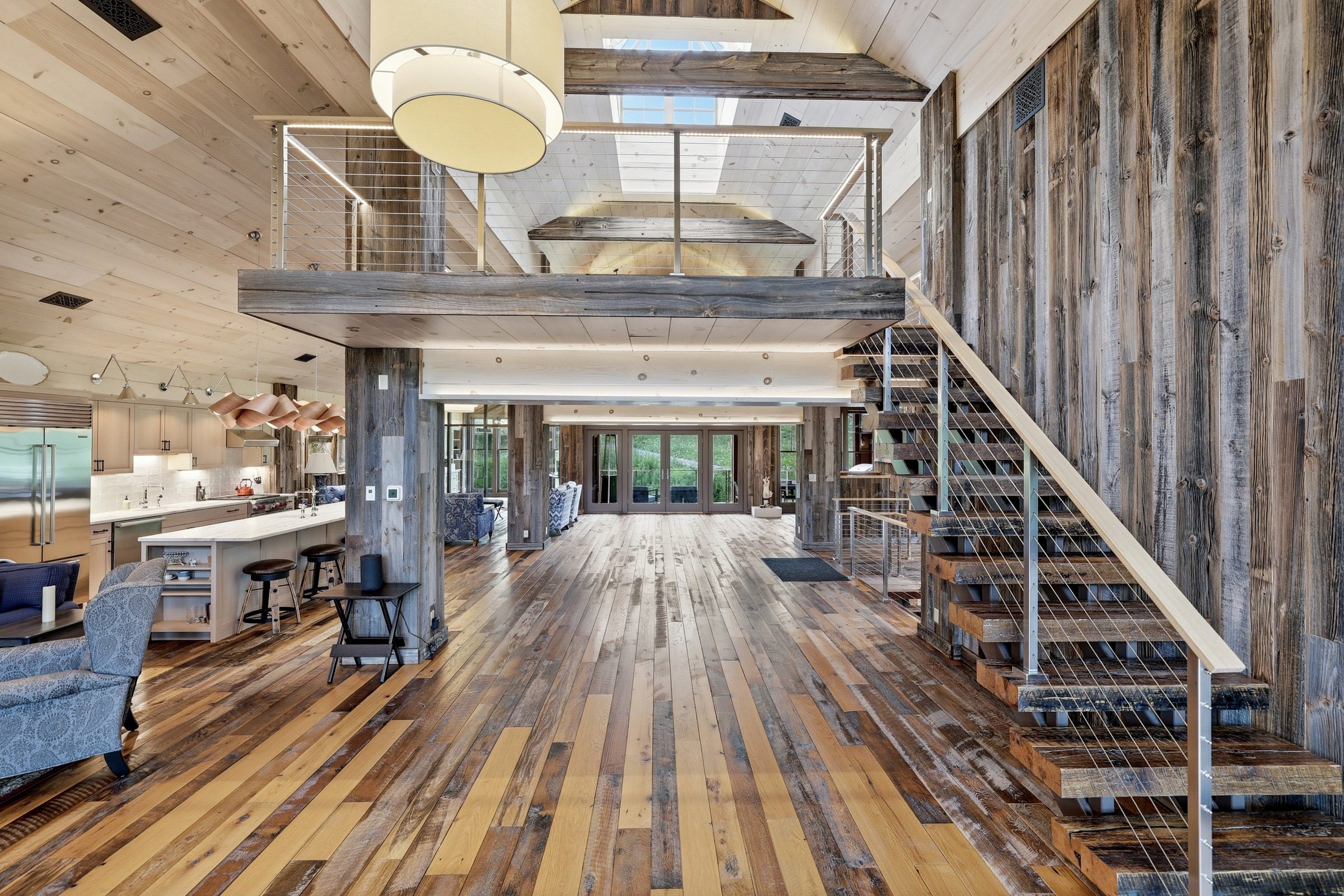 The barn's mezzanine and custom stair, lit from skylights above