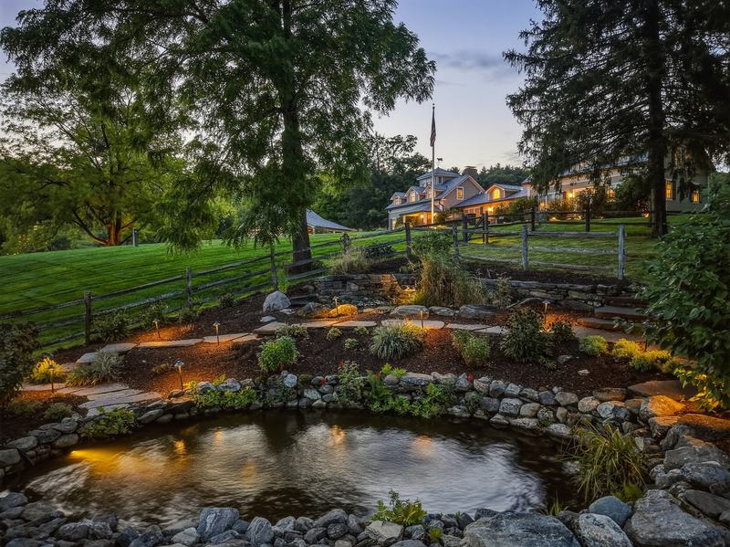 The pond, with the residence at dusk beyond